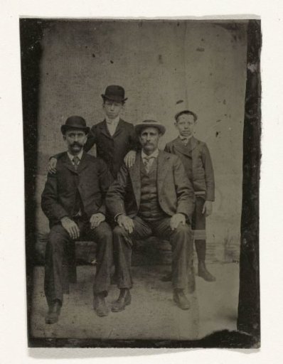 Portrait of Two Men and Two Boys, Standing and Sitting in Front of a Painted Backdrop (Pond?)