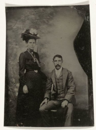 Portrait of a Man and a Woman, One Standing and One Sitting, in Front of a Painted Backdrop (Trees)