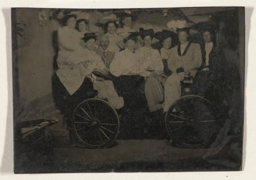 Group Portrait of Ten Women and One Man, Huddled Together on a Carriage in a Studio