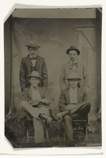 Portrait of Four Men, Standing and Sitting in Front of a Painted Backdrop (Architecture)