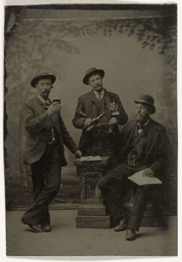 Portrait of Three Men with Bottles and Glasses, Standing and Sitting in Front of a Painted Backdrop (Trees)