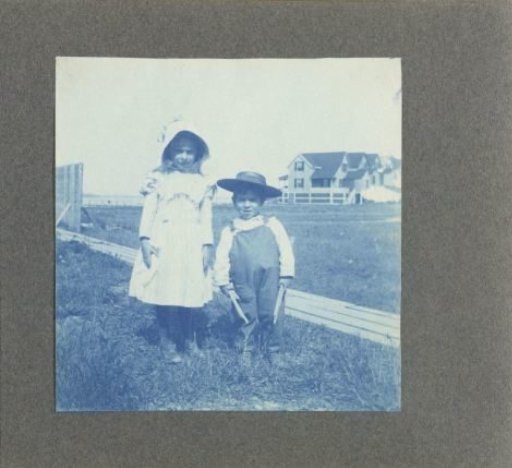 Two children by a fence, United States