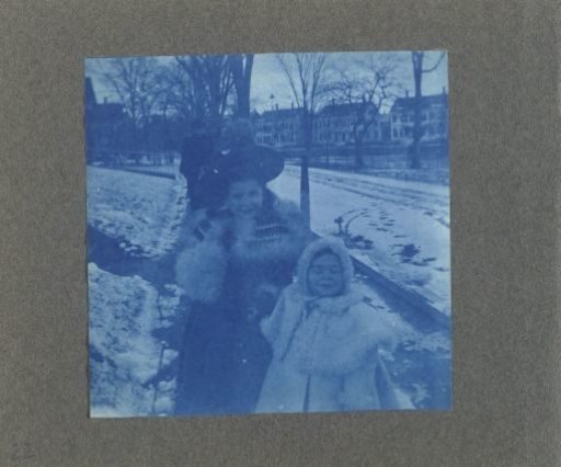 Two children on the street in the snow, United States