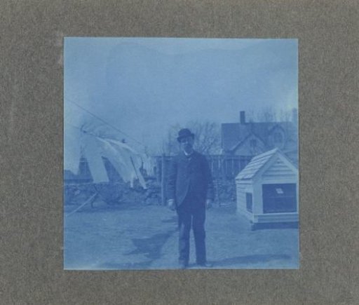 Man standing by a clothesline in a garden, United States