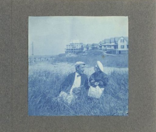 Man with a child sitting by a beach, United States