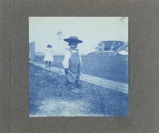 Two children by a fence, United States