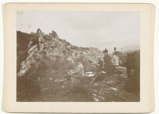 Group portrait of travelers and helpers during a picnic in the mountains, in France or Italy