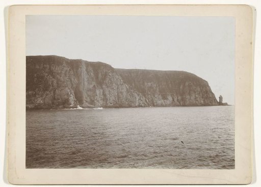 Cliff extending into the sea (fjord in Norway?)