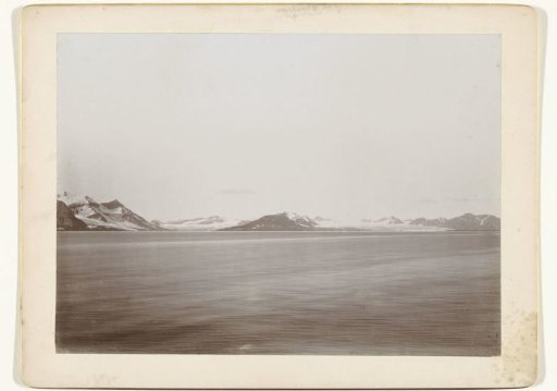 View over a lake or sea with snow-capped mountains in the background (Norway?)