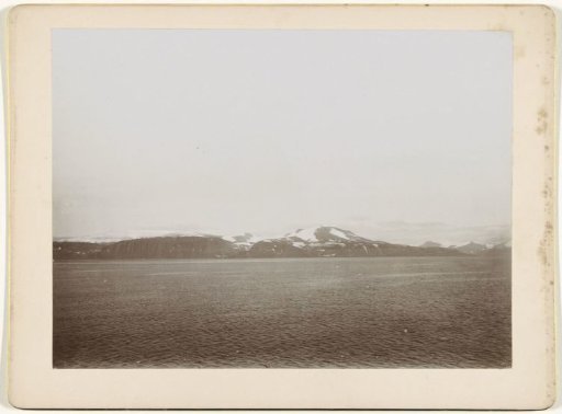 View over a lake or sea, with snow-capped mountains in the background (Norway?)