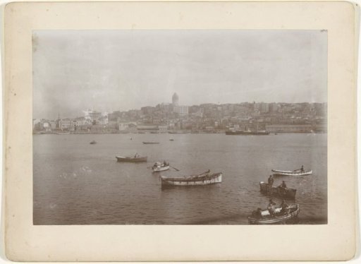 View of a seaside town with rowing boats in the foreground