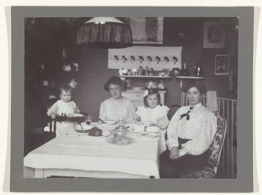 Portrait of two nannies, Nanny Brooks and Daisy Brooks, with Renée and Sacha seated at a table