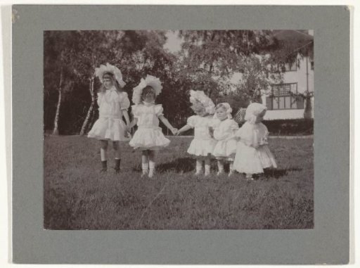 Portrait of five girls holding hands in a garden, probably the five daughters of the photographer