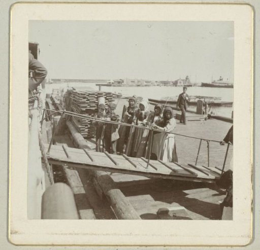 Gangway of the Norra Finland with children playing musical instruments in the background