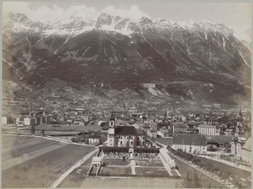 Panoramic view of Innsbruck with snow-capped mountain peaks in the background
