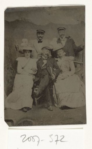 Group Portrait of Three Men and Two Women in Clearly Cheerful Spirits, Standing and Sitting Before a Painted Backdrop Depicting a Mountain with a Castle