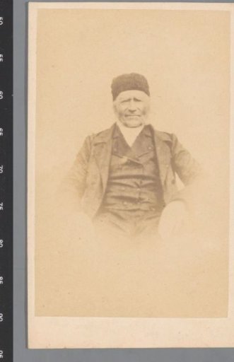 Portrait of an old man wearing a fur cap