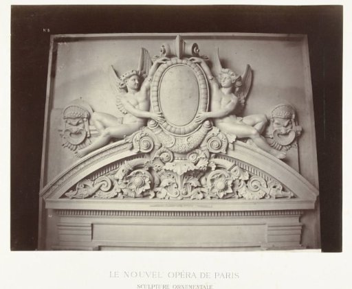 Relief above the doorpost with male angels placed next to a medallion and above ornaments