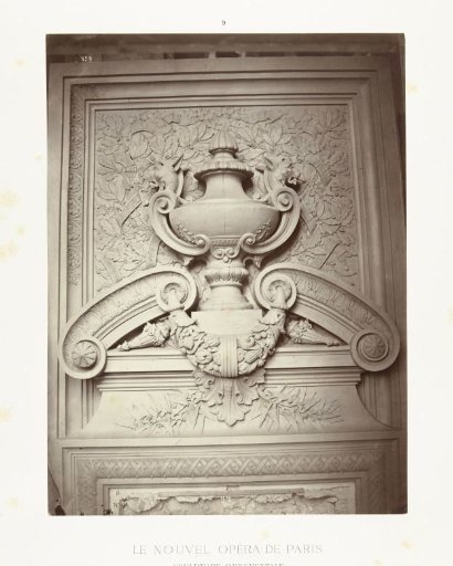 Goblet in relief with dog heads at the ears, the goblet is surrounded by leaves
