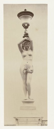 Floor lantern in the form of a naked lady, holding a chalice on her head