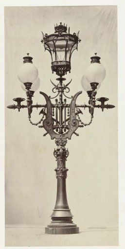 Floor lantern with four large glass globes and a central lantern, the bronze frame is decorated