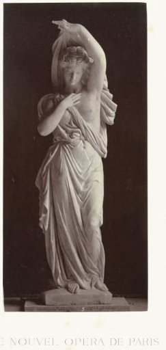 Marble statue of a woman in a toga with a partially exposed upper body.