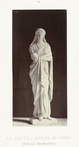 Marble statue of a woman in a toga with arms crossed.