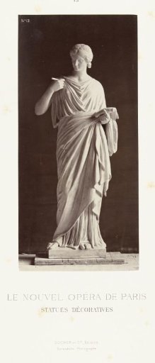 Marble statue of a woman in a toga holding a paper and a pen in her hands.