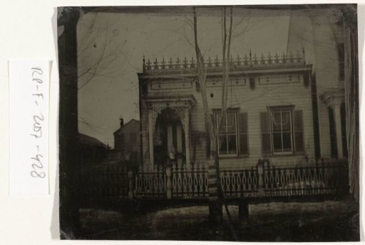 View of a wooden house in New Jersey (Seaman Avenue?), USA, with two people (Hester and Arline Moore?) in the doorway