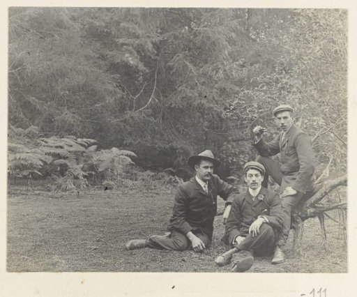 Three friends of Dolph Kessler on a grassy field