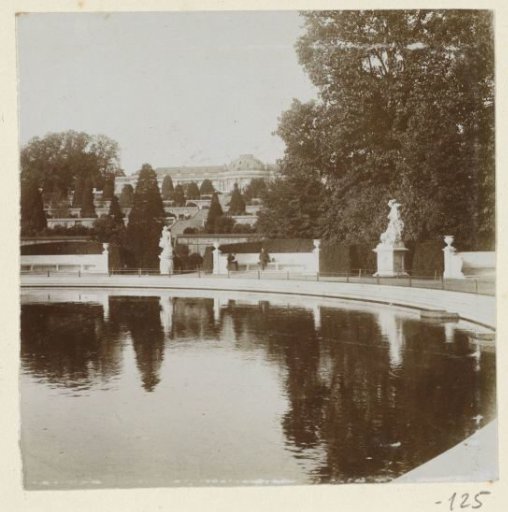 View of a country house with a pond and statues, probably in England