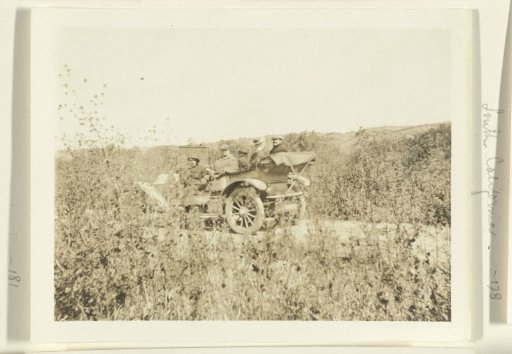 Company traveling by car through California on a tour of the oil fields