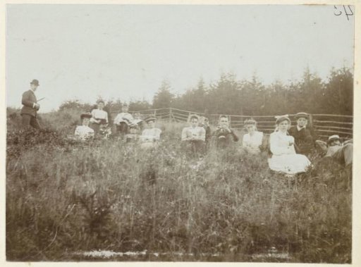 The Kessler and Heyning families resting in tall grass, probably during a walk in the Harz
