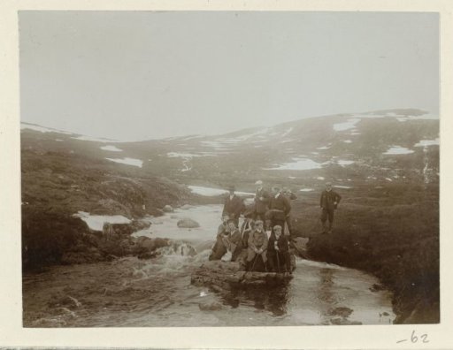 The group resting on a rock above a mountain in the Harz