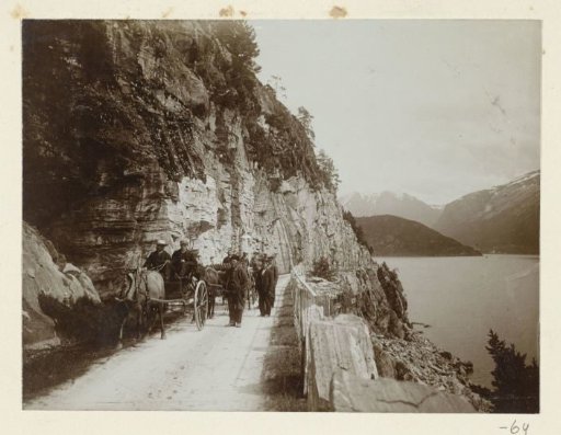 Carriages on a mountain road along a lake in the Harz