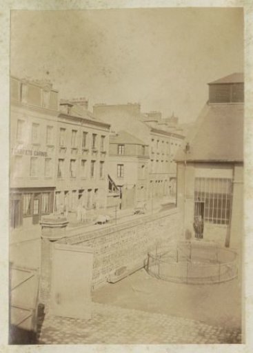 Street scene in France with a furniture workshop and schoolyard