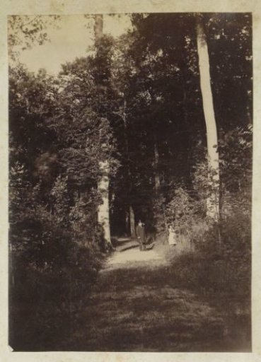 Man and a child on a forest path in France