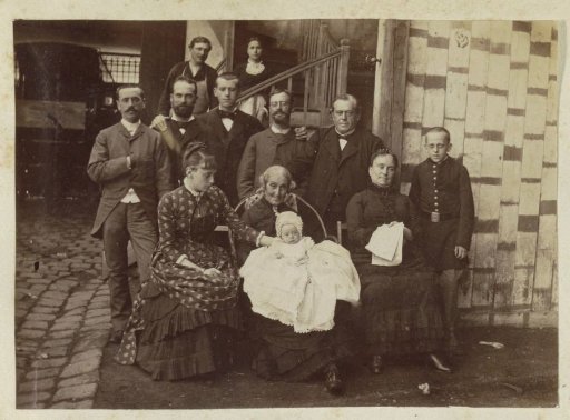 Group portrait of a French family by a barn