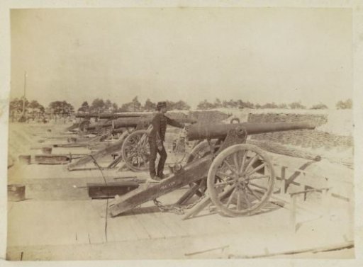 Military position in France with cannons and soldiers standing on carriages