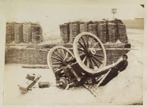 French soldier lying next to an overturned cannon
