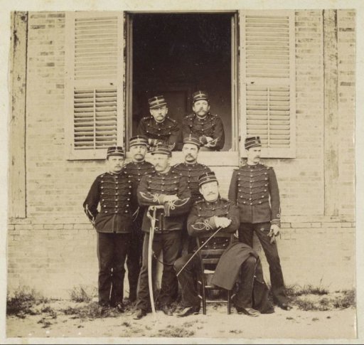 Group portrait of eight French soldiers by a window