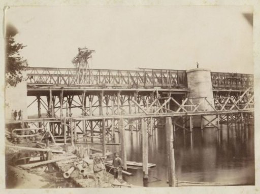 Bridge under construction in France, with a diver in the foreground