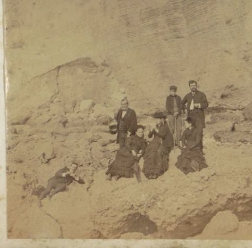 Group in front of a rock wall, presumably at Etretat