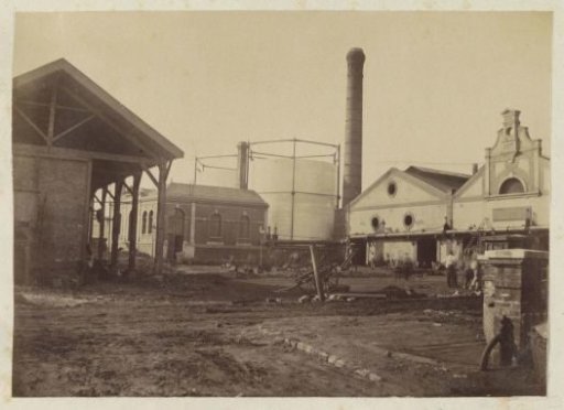 Factory grounds with gas holder, chimney and buildings in France