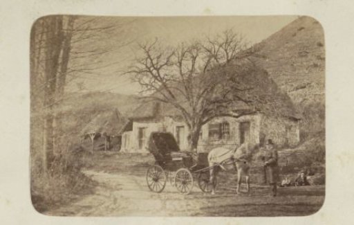 Man with horse and cart on a road in France, a woman and child in the ditch