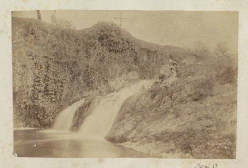 Group lying beside a waterfall in France