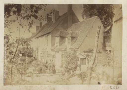 Two women in Japanese kimonos standing before a house in France