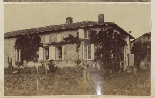 Country house with garden in France, with inhabitants in the windows