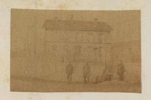 Four men in front of a house in France