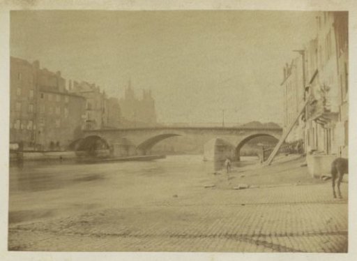 City view with a quay and a bridge, probably in France
